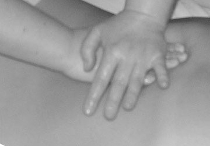 Massage therapist treating a client's back